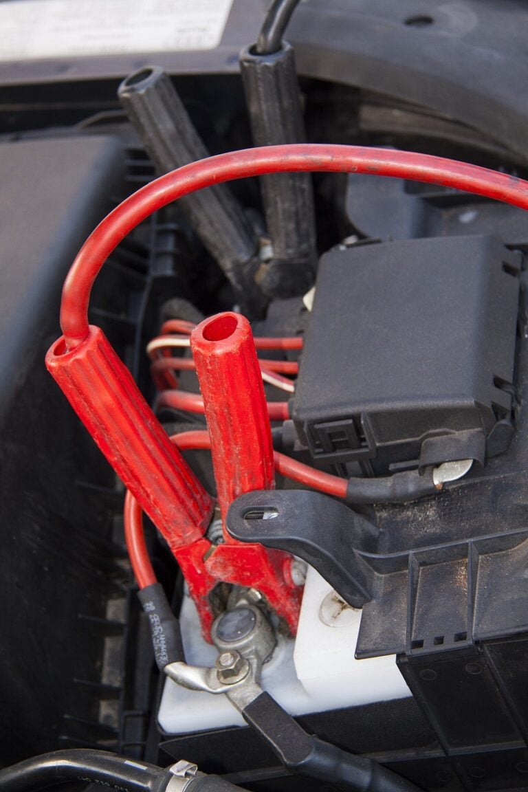 Jumper cables on a truck battery needing emergency road service